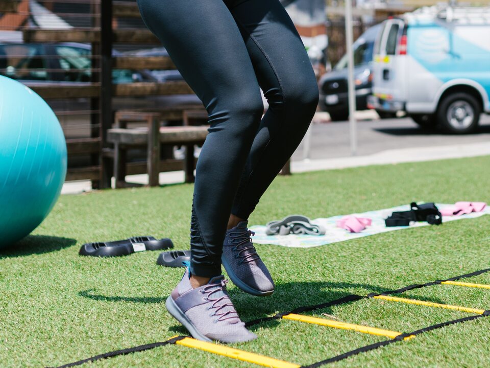 An athlete completing an agility ladder training drill